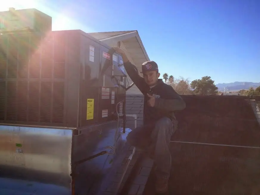 HVAC technician performing HVAC Inspection on a rooftop unit in South Valley